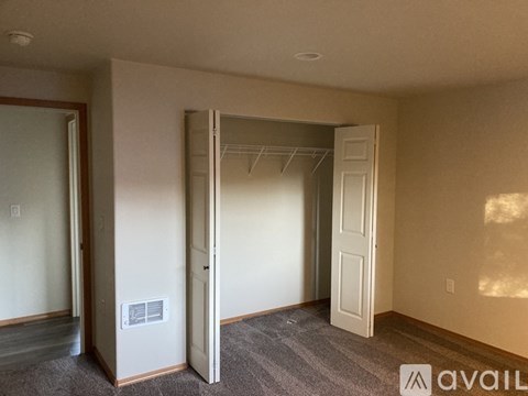 A room with a door and a wall socket.