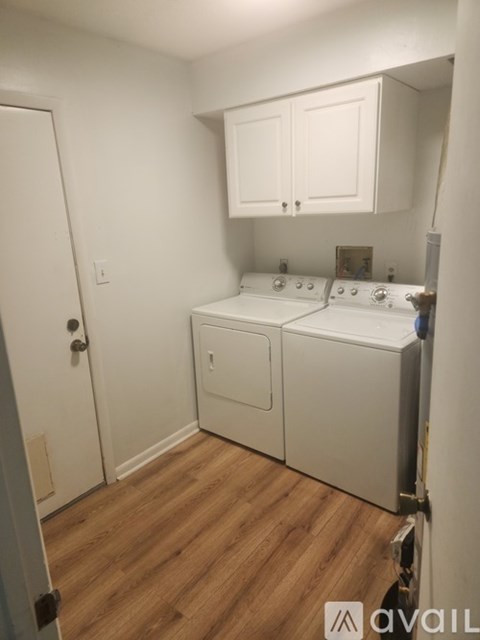 A small laundry room with a washer and dryer.