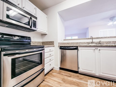 A kitchen with a stainless steel oven and microwave above a dishwasher.
