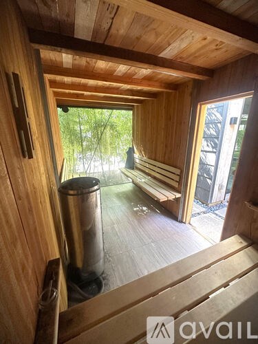 A wooden room with a window and a door.