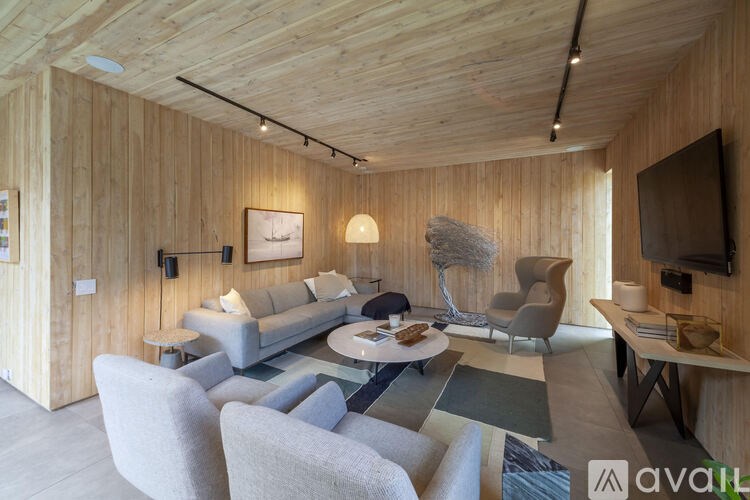 A living room with wooden walls and furniture.
