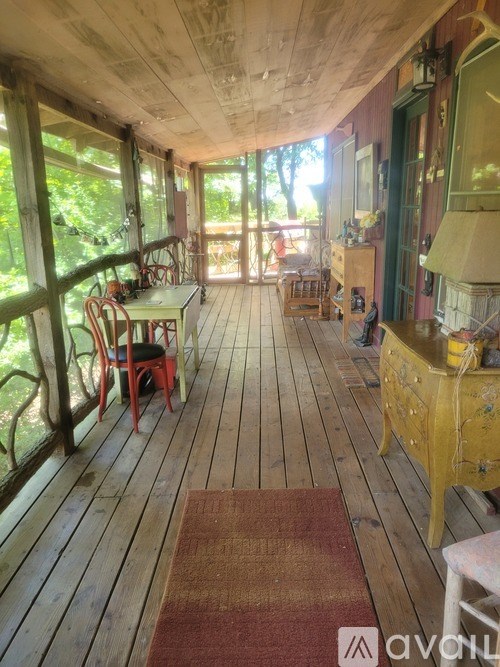 A wooden deck with a table and chairs.