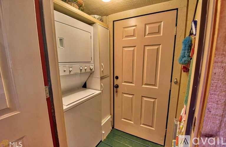 A white oven and microwave are in a small kitchen.