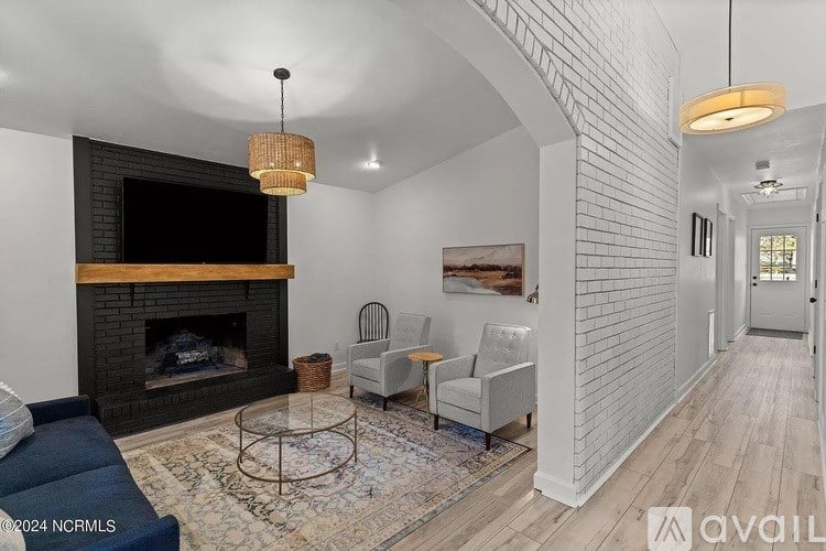 A living room with a fireplace and a television.