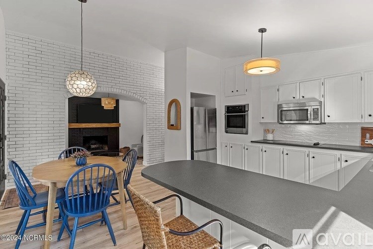 A modern kitchen with a dining table and chairs.
