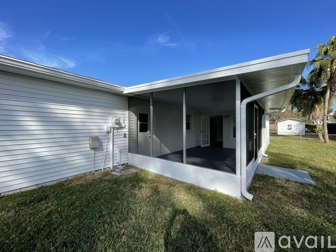 A house with a white exterior and a covered patio area.