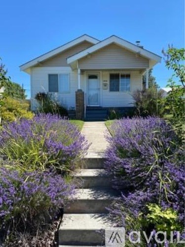 A house with a white door and a small porch with a step leading to it.