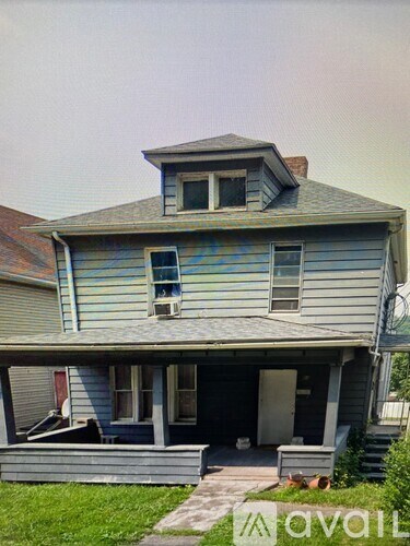 A blue house with a white door and a window.