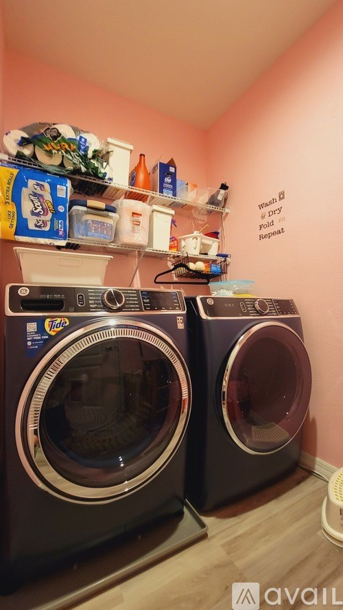 Two front loading washing machines in a laundry room.