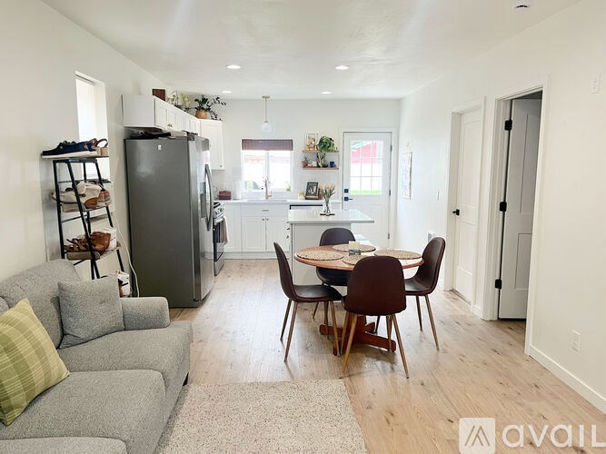 A kitchen with a table and chairs in the middle of the room.