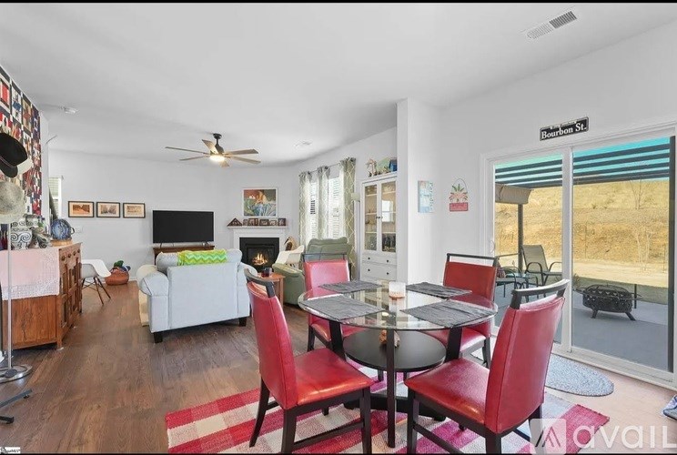 A dining room with a table set for six and a television in the corner.