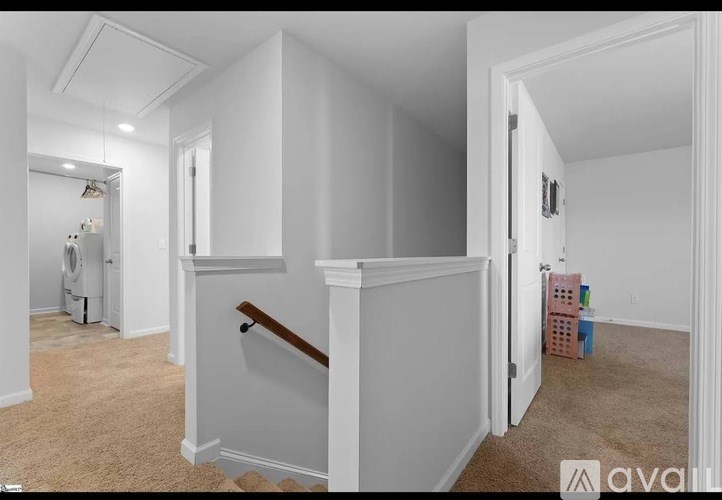 A room with white walls and a carpeted floor.