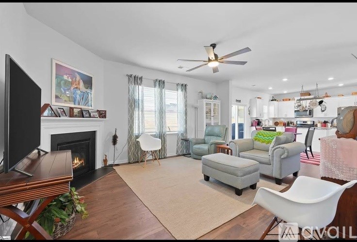 A living room with a fireplace and a television.