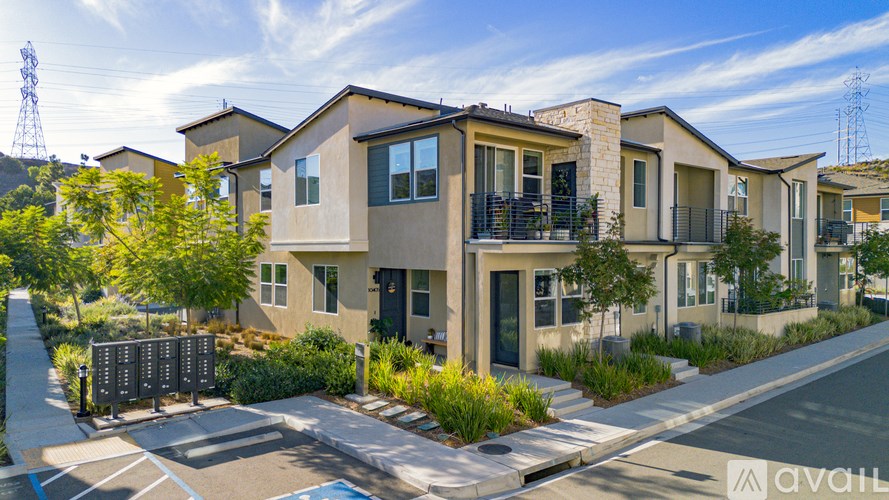 A row of modern houses with a clear sky above them.