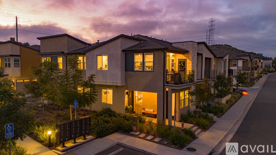 A row of houses with a sunset in the background.