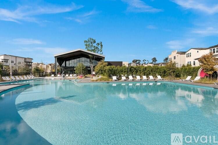 A large swimming pool with a building in the background.