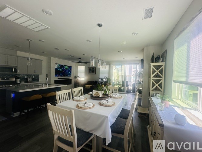 A dining room with a table set for a meal.