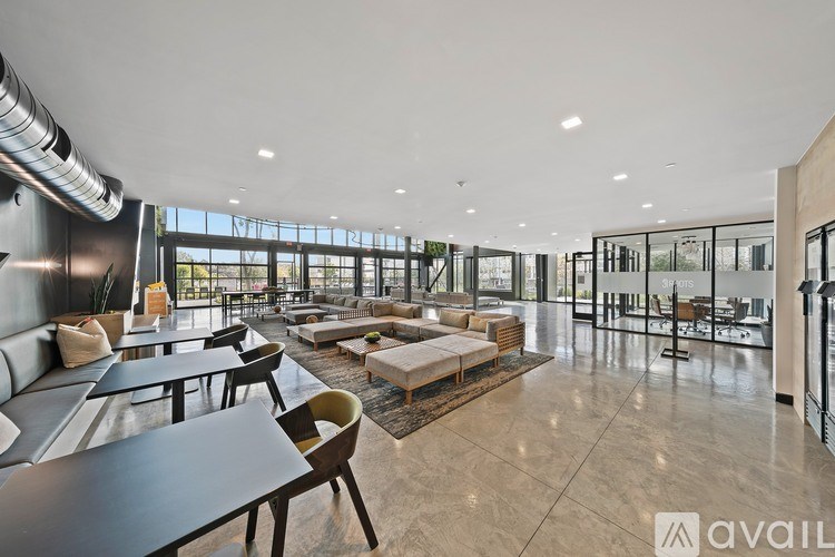 A spacious, modern dining area with a view of the outdoors.