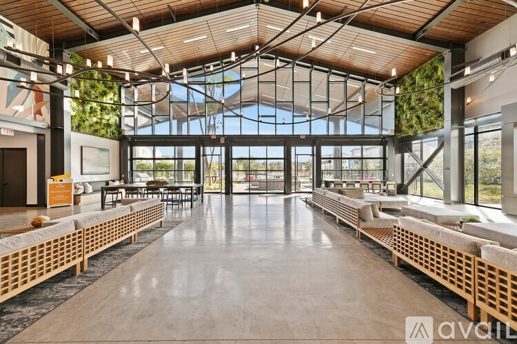 A spacious indoor area with wooden benches and a glass ceiling.
