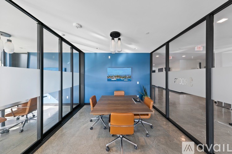 A conference room with a long table and chairs.