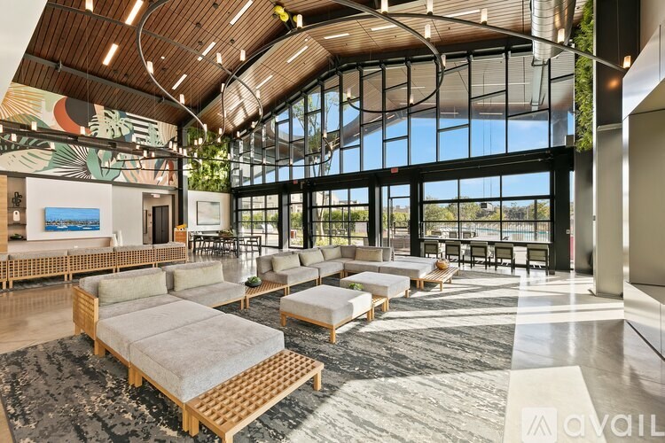 A modern living room with a wooden floor and a large window.