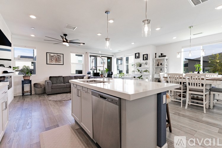 A bedroom with a bed, nightstand, and a ceiling fan.
