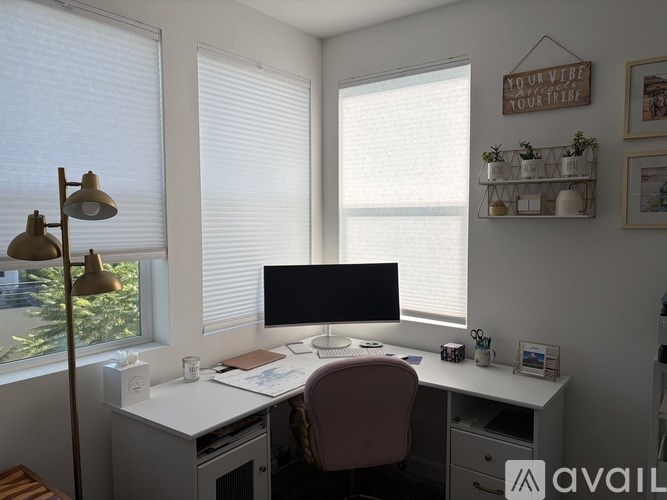 A modern kitchen with a refrigerator, microwave, and oven.