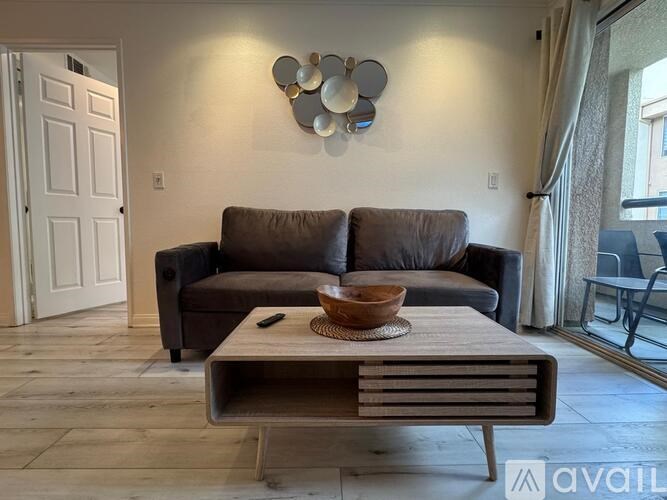 A living room with a brown couch and a wooden coffee table.
