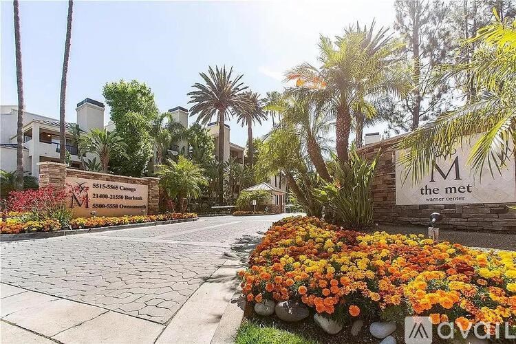 The entrance to a residential complex with a sign that reads "The Met".