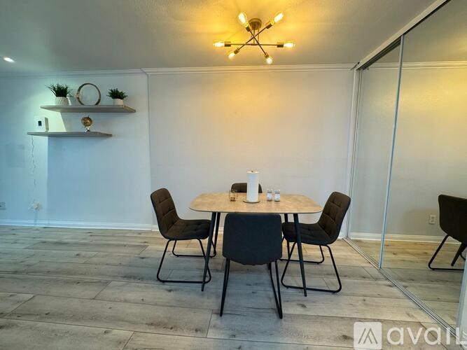 A dining room with a round table and chairs.