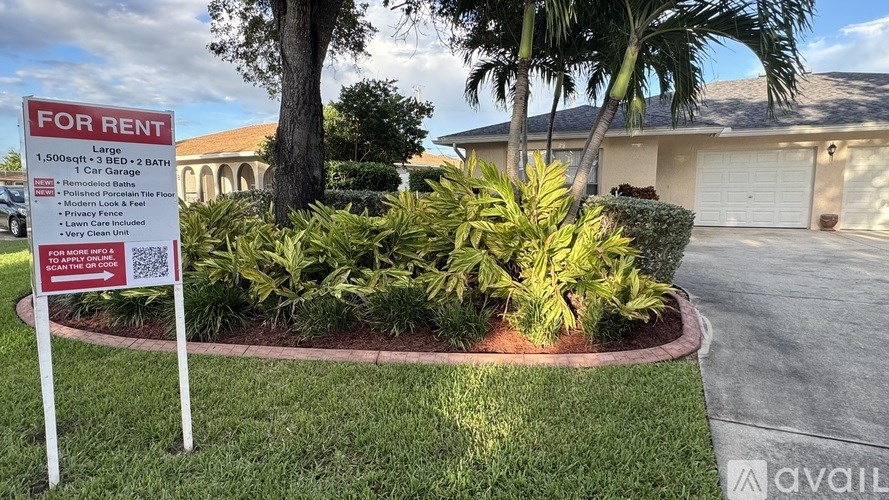 A house is for rent with a sign in front of it.