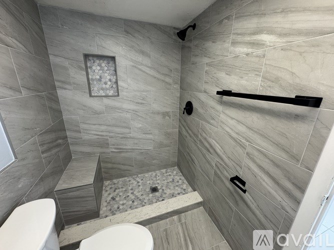 A bathroom with a toilet, a sink, and a shower.