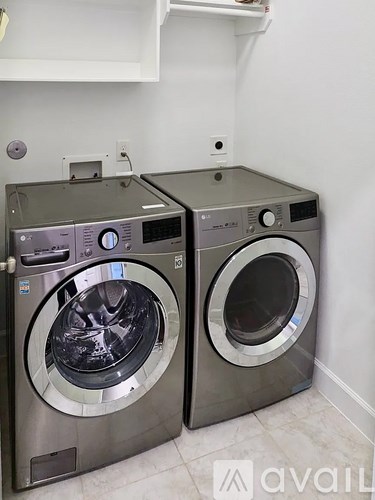 Two front load washing machines in a laundry room.