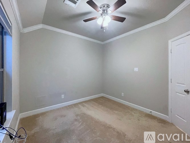 A room with a ceiling fan and a light fixture.