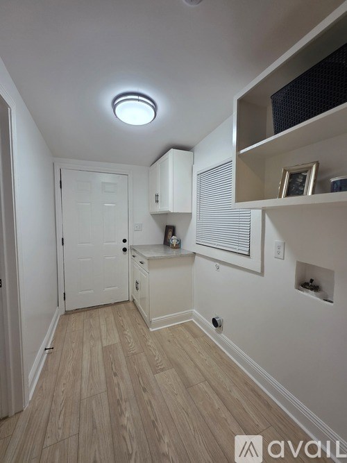 A backyard with a gravel path and a wooden fence.