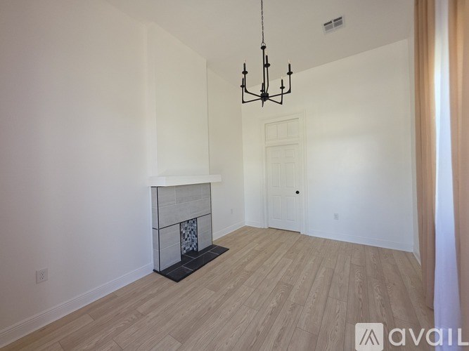 A room with wooden floors and a chandelier.