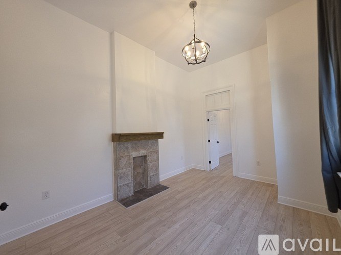 A room with a fireplace and a chandelier.