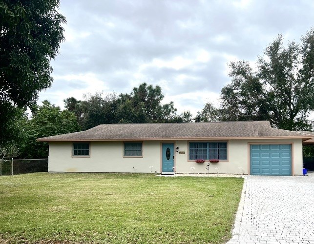 A house with a blue door and a grey roof.