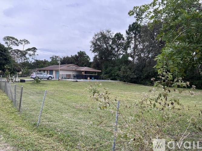 A house with a fence in front of it.