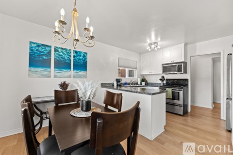 A kitchen with a dining table set for four.