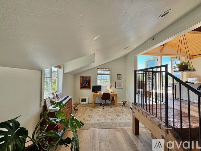 A living room with a balcony and a large window.