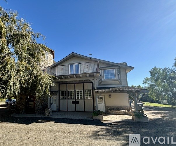 A house with a garage and a driveway in front of it.