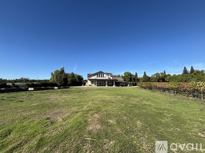 A large open field with a building in the distance.