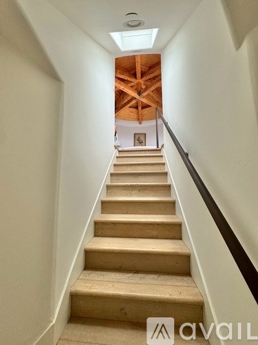 A staircase with a skylight above it.
