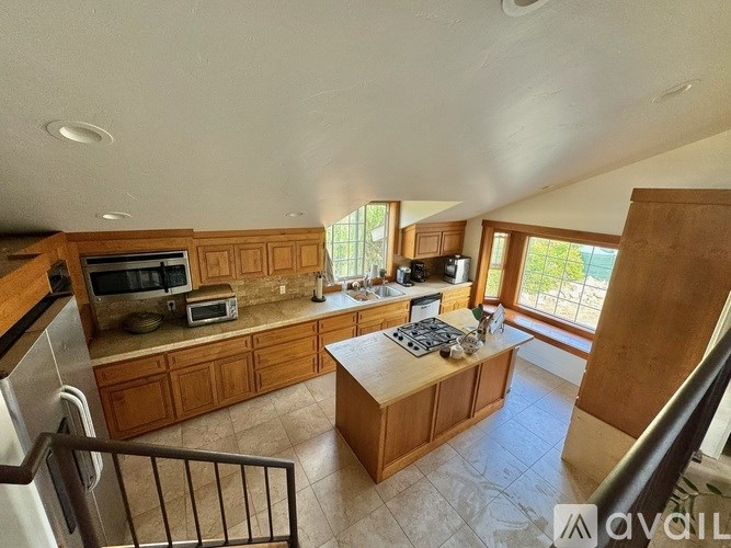 A kitchen with wooden cabinets and a tiled floor.