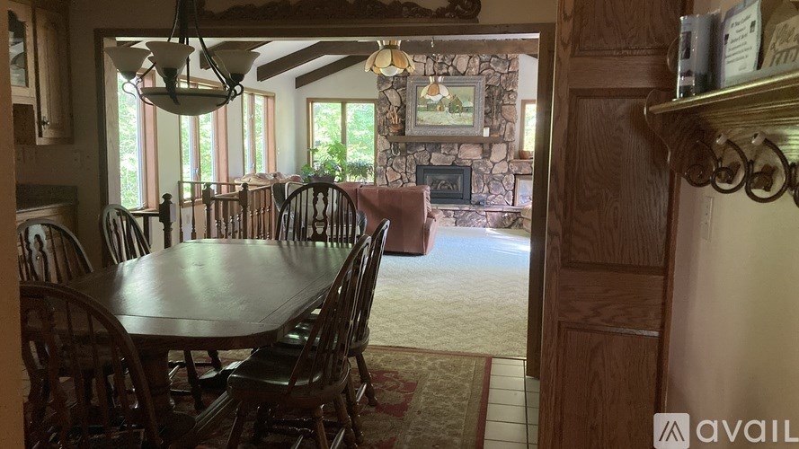 A dining room with a table and chairs.
