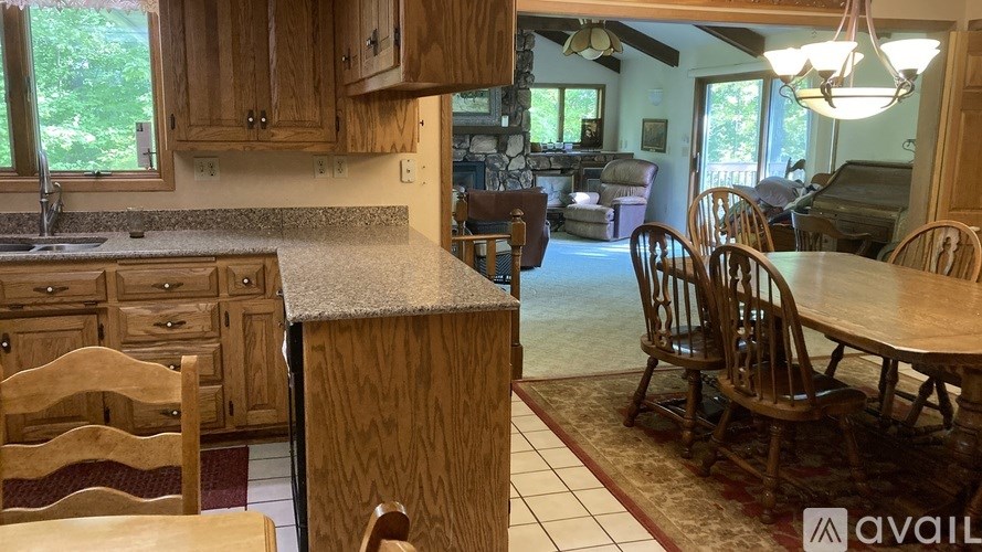 A kitchen with wooden cabinets and a granite countertop.