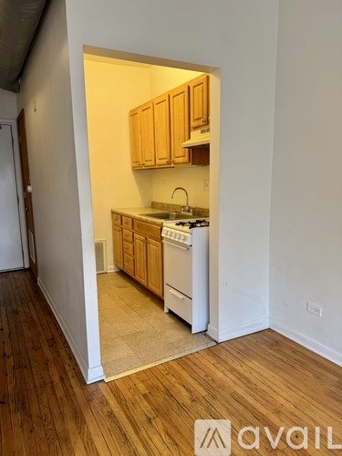 A kitchen with wooden cabinets and a white stove top oven.