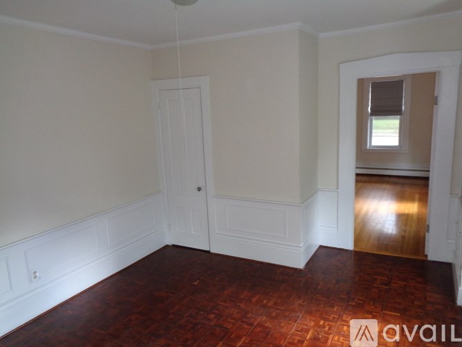 A room with a wooden floor and white walls.