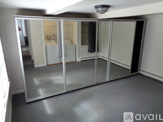 A room with a sliding door and a grey carpet.